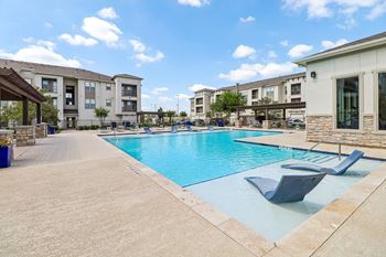Resort-style swimming pool with expansive tanning areas